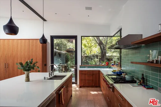 a kitchen that has a sink and a stove
