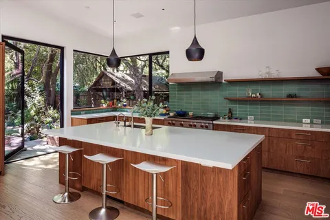 a view of a kitchen with a table and chairs