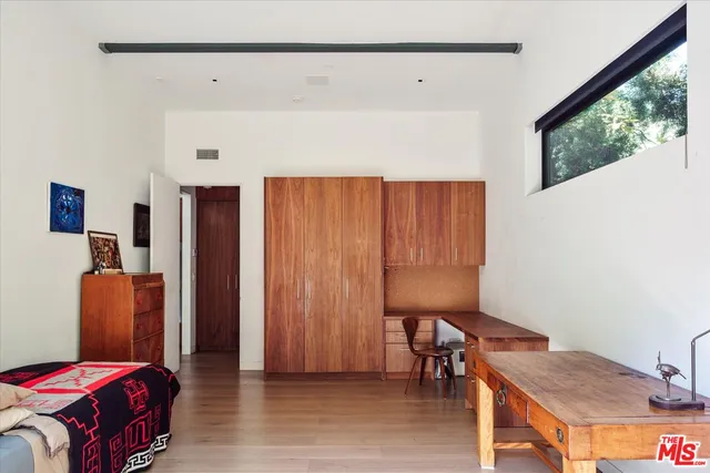 a bedroom with furniture and a window