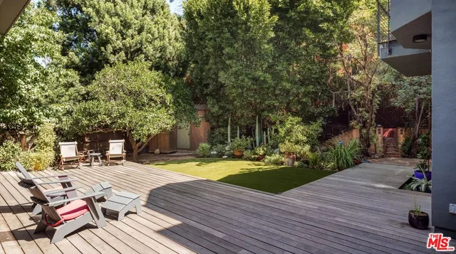 a view of a backyard with sitting area
