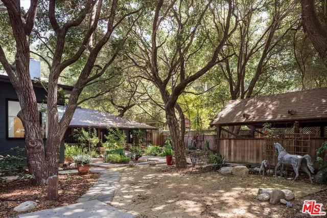 a view of a patio with a table and chairs under an umbrella