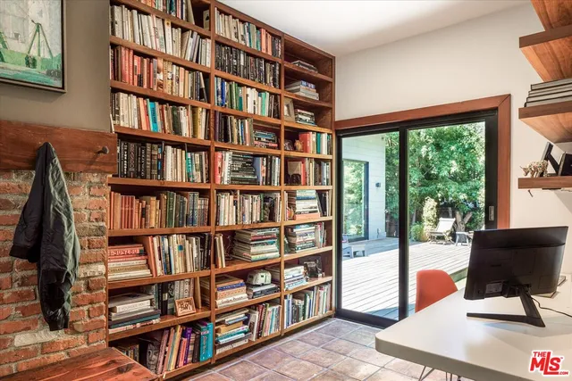 a view of a livingroom with furniture and a book shelf