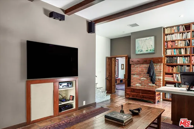 a living room with fireplace furniture and a flat screen tv