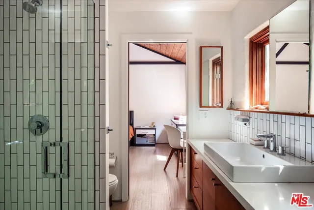 a bathroom with a tub sink and mirror
