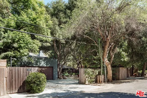 a street sign on a sidewalk next to a road