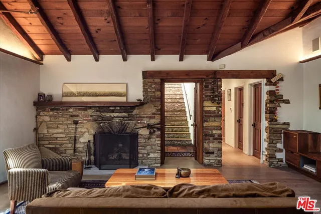 a living room with furniture flat screen tv and a fireplace