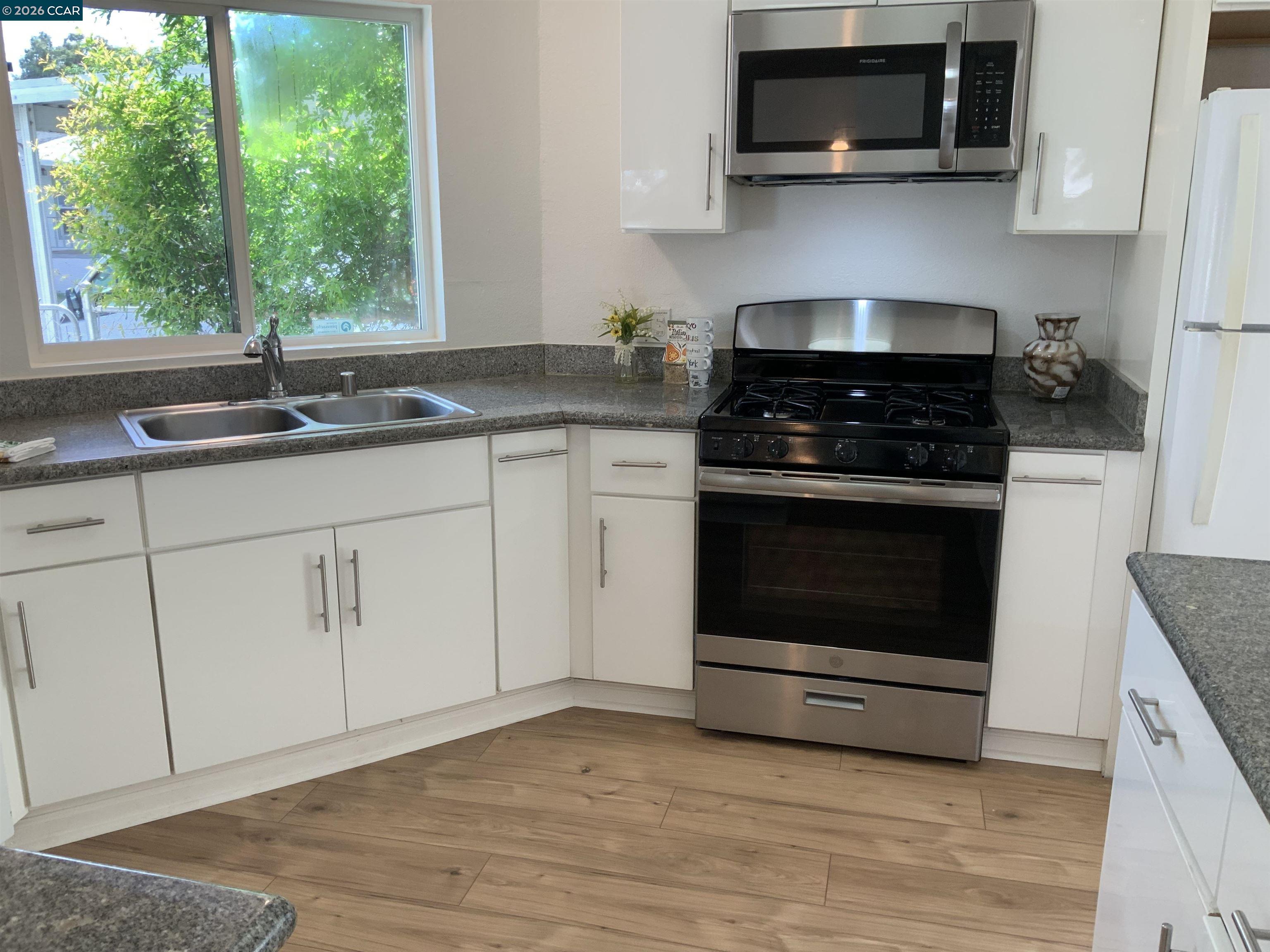 140 Shannon Pittsburg, CA 94565 - Photo 11 of 37 a kitchen with white cabinets stainless steel appliances and a sink