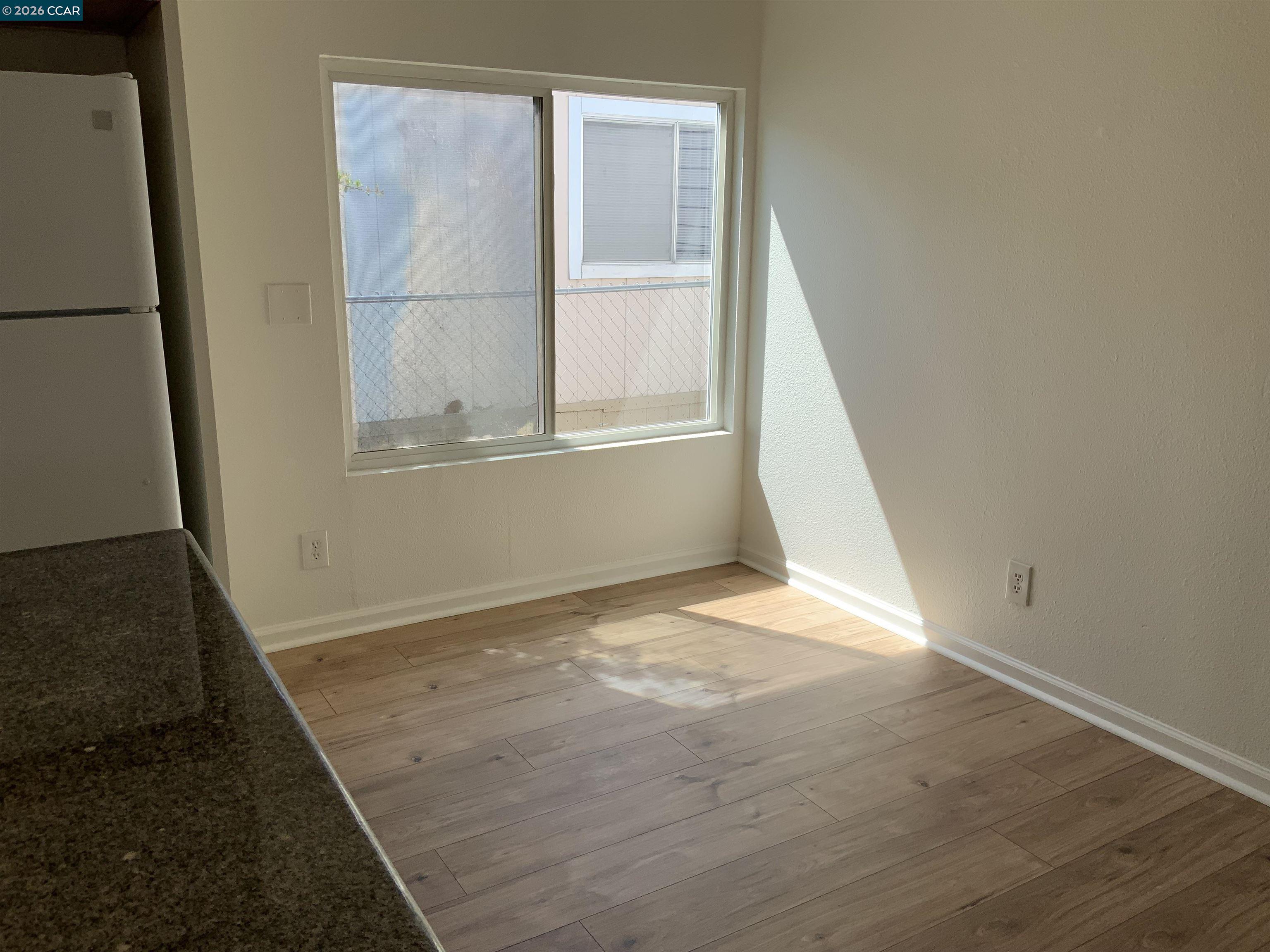 140 Shannon Pittsburg, CA 94565 - Photo 15 of 37 an empty room with wooden floor and windows