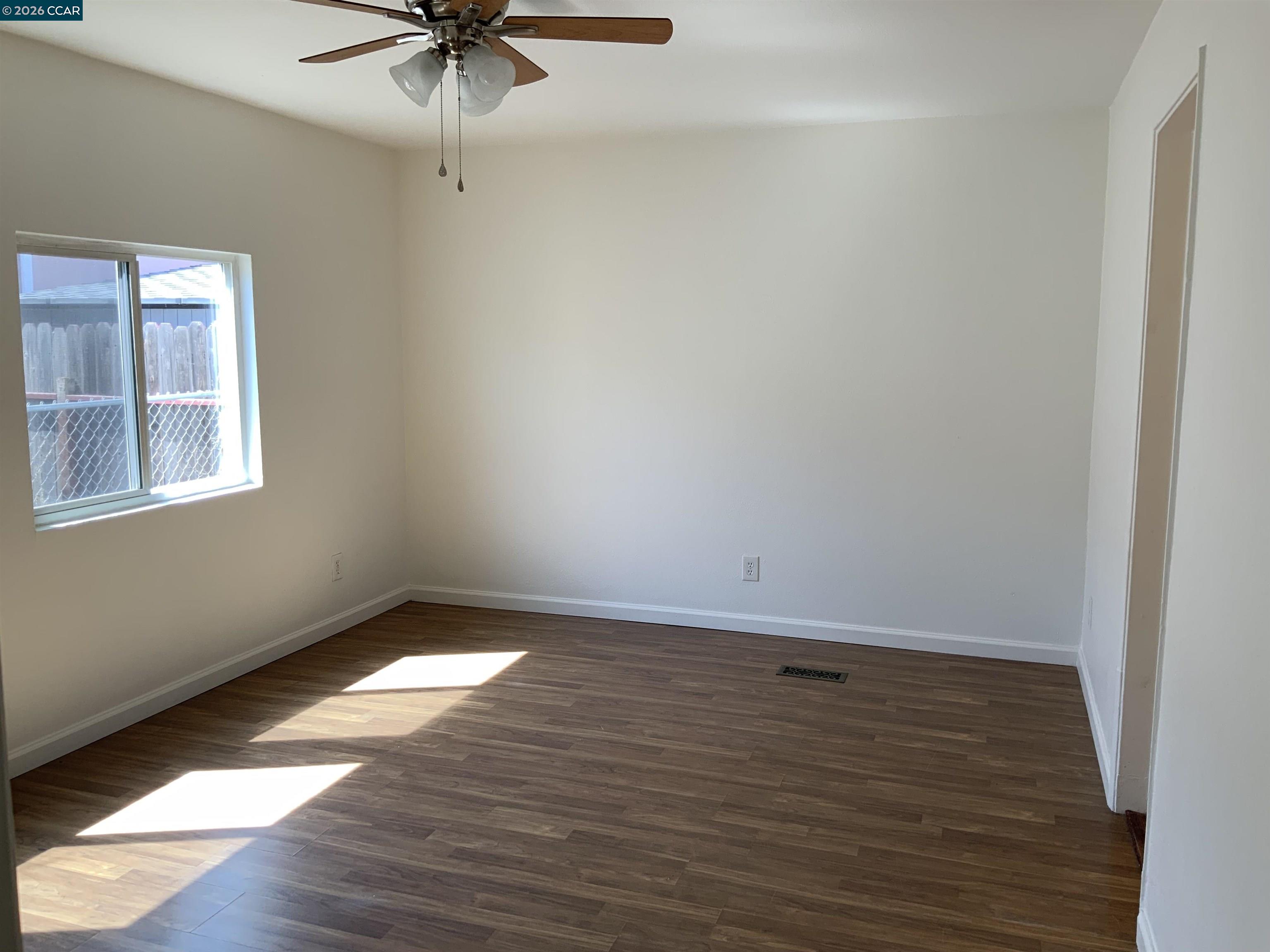 140 Shannon Pittsburg, CA 94565 - Photo 24 of 37 a view of an empty room with a window and wooden floor