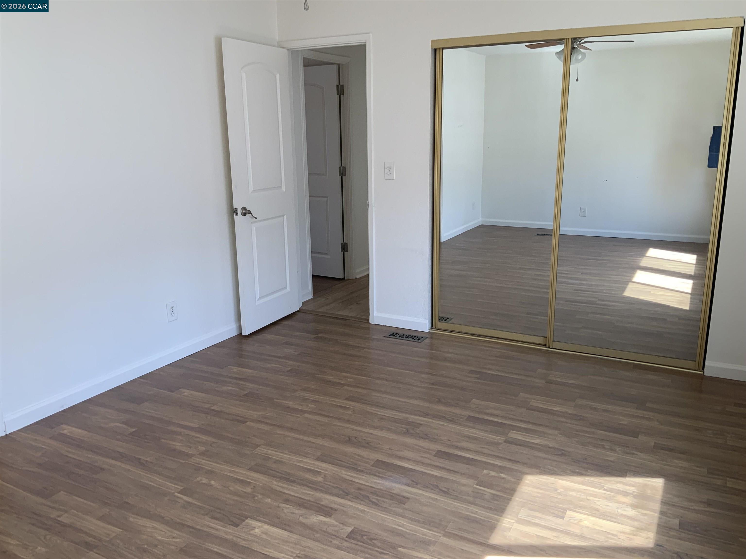 140 Shannon Pittsburg, CA 94565 - Photo 25 of 37 an empty room with wooden floor and entrance