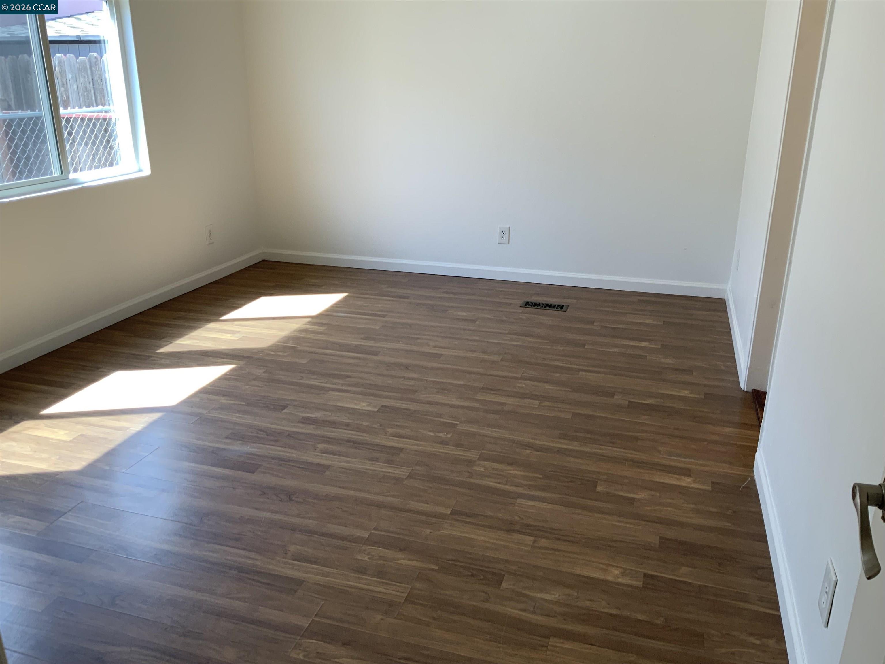 140 Shannon Pittsburg, CA 94565 - Photo 26 of 37 a view of an empty room with wooden floor and a window
