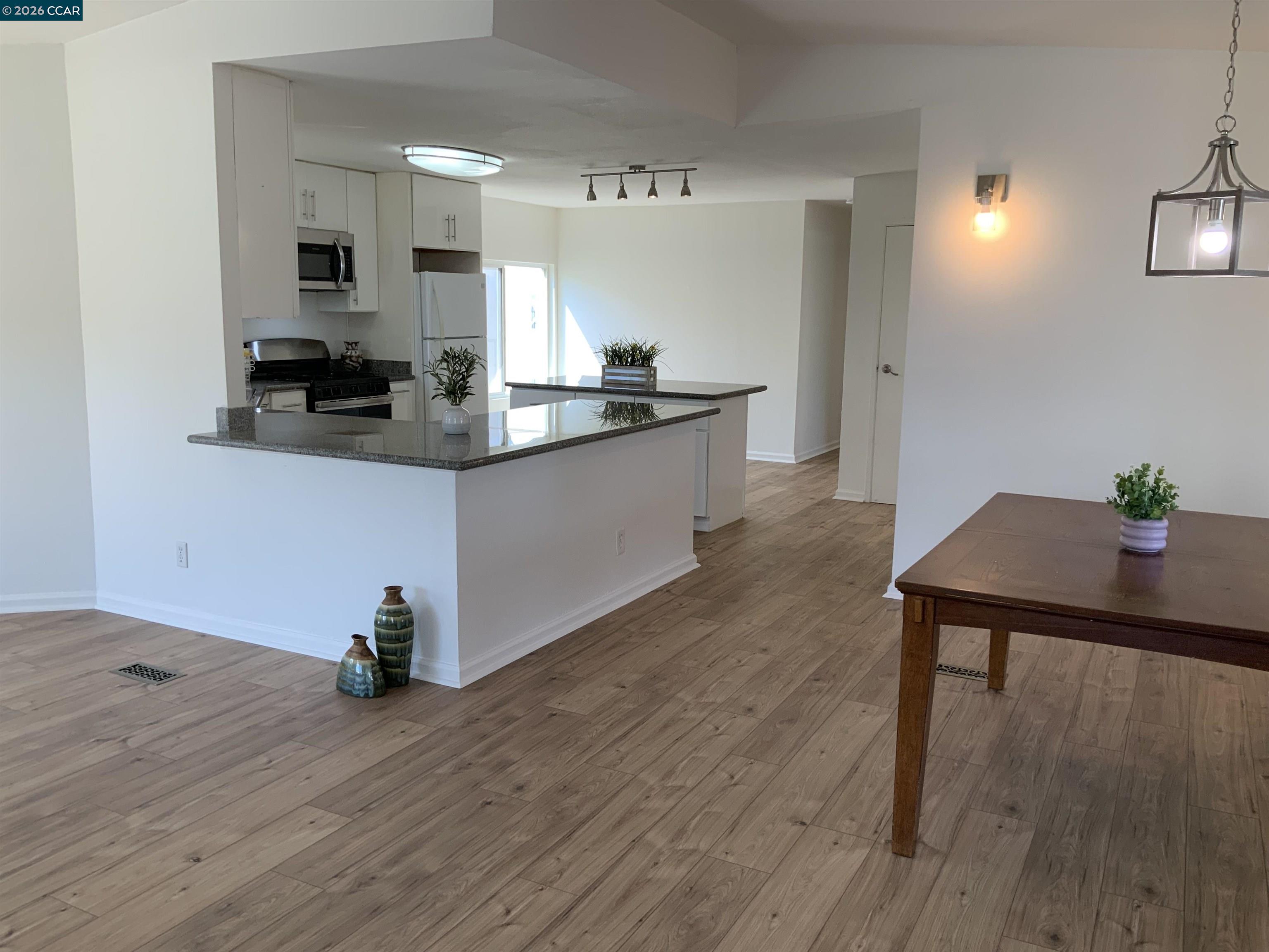 140 Shannon Pittsburg, CA 94565 - Photo 5 of 37 a kitchen with granite countertop white cabinets and appliances
