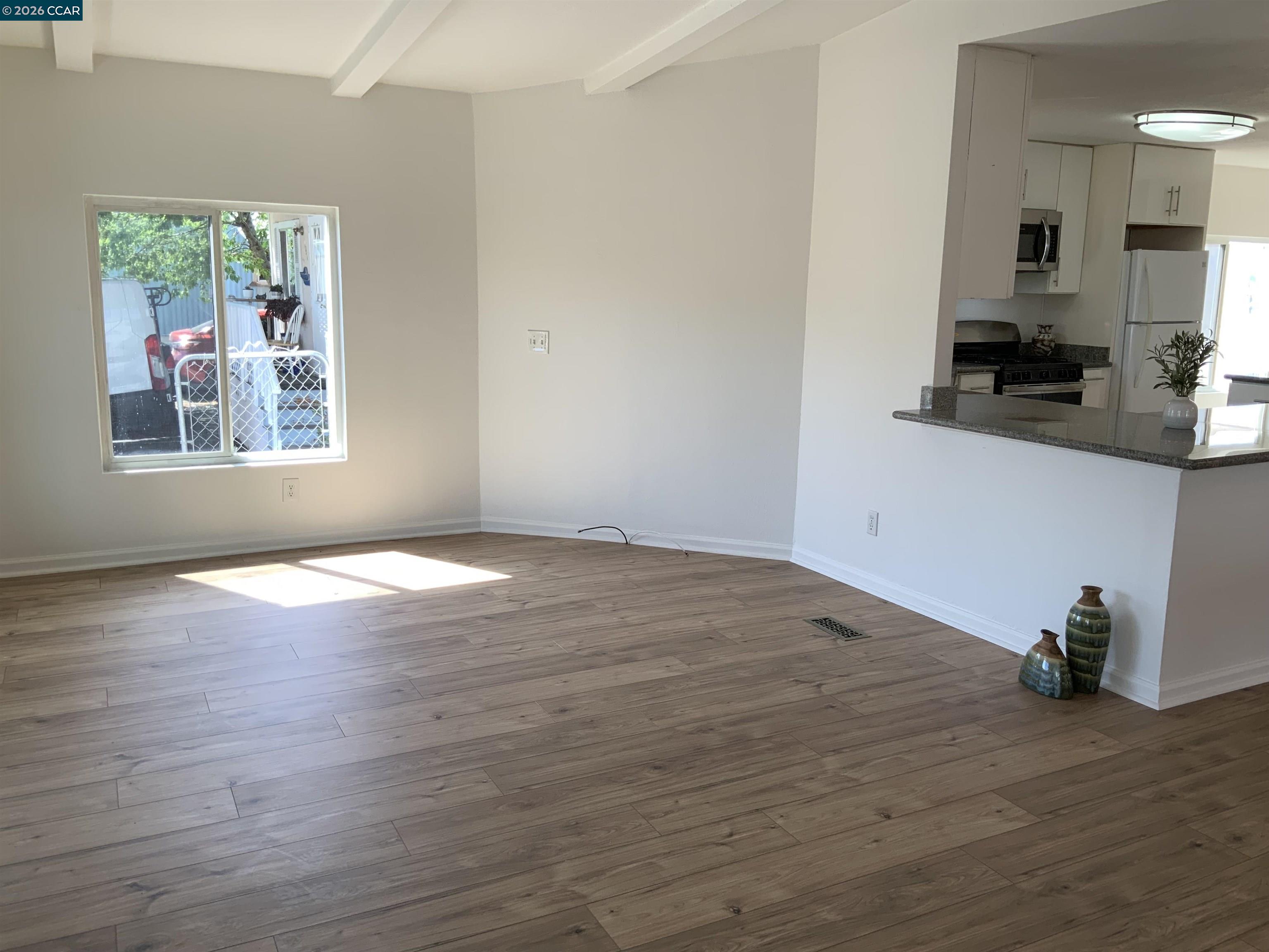 140 Shannon Pittsburg, CA 94565 - Photo 7 of 37 a view of a kitchen with wooden floor and a window