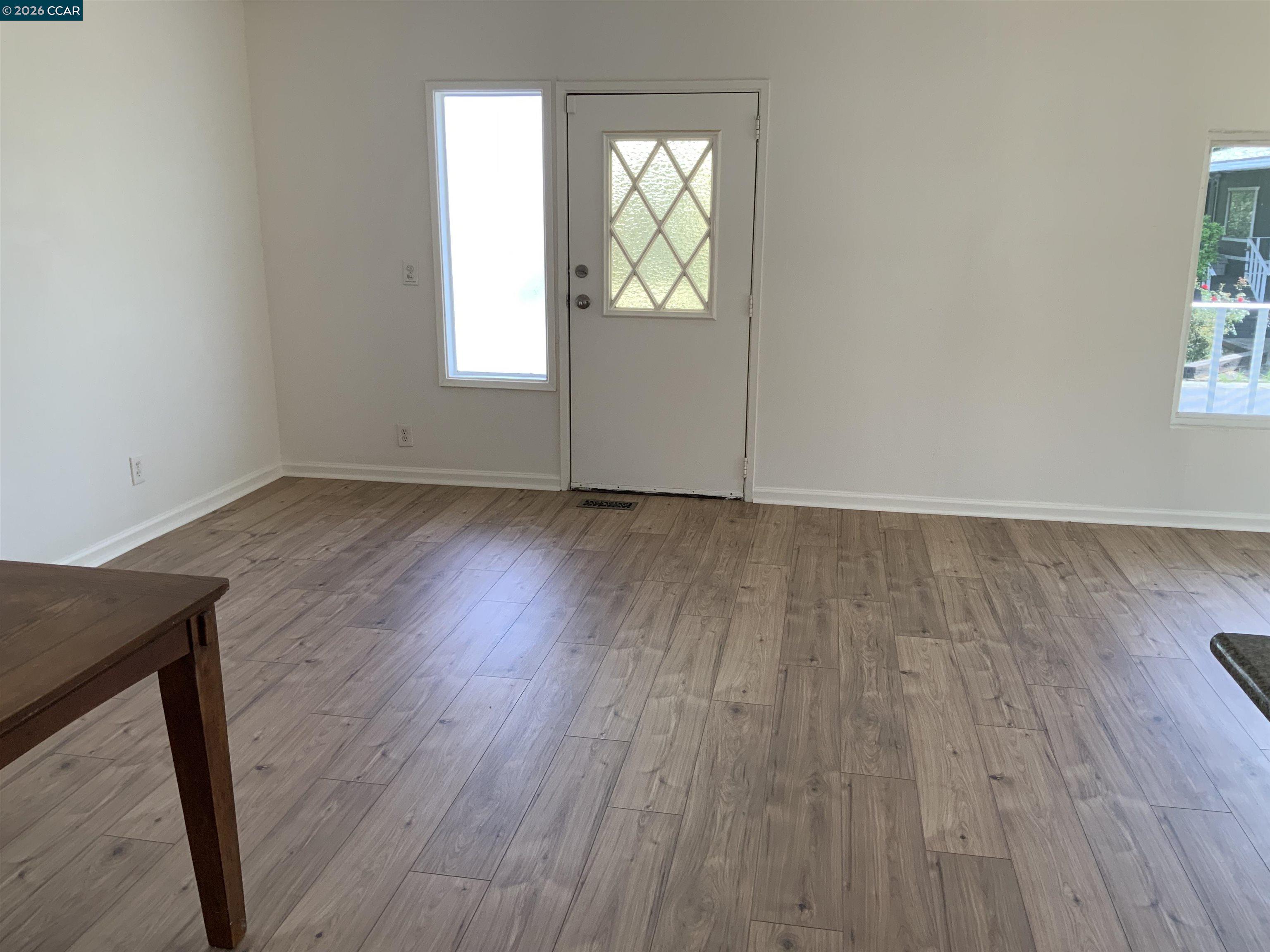 140 Shannon Pittsburg, CA 94565 - Photo 9 of 37 an empty room with wooden floor and windows