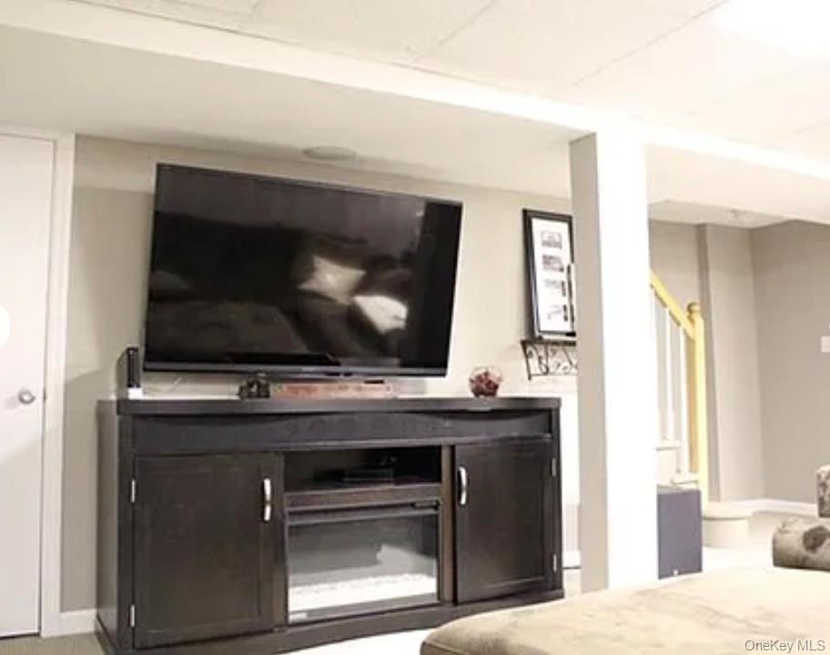 78-45 79th Place Queens, NY 11385 - Photo 15 of 36 a living room with a fireplace and a flat screen tv