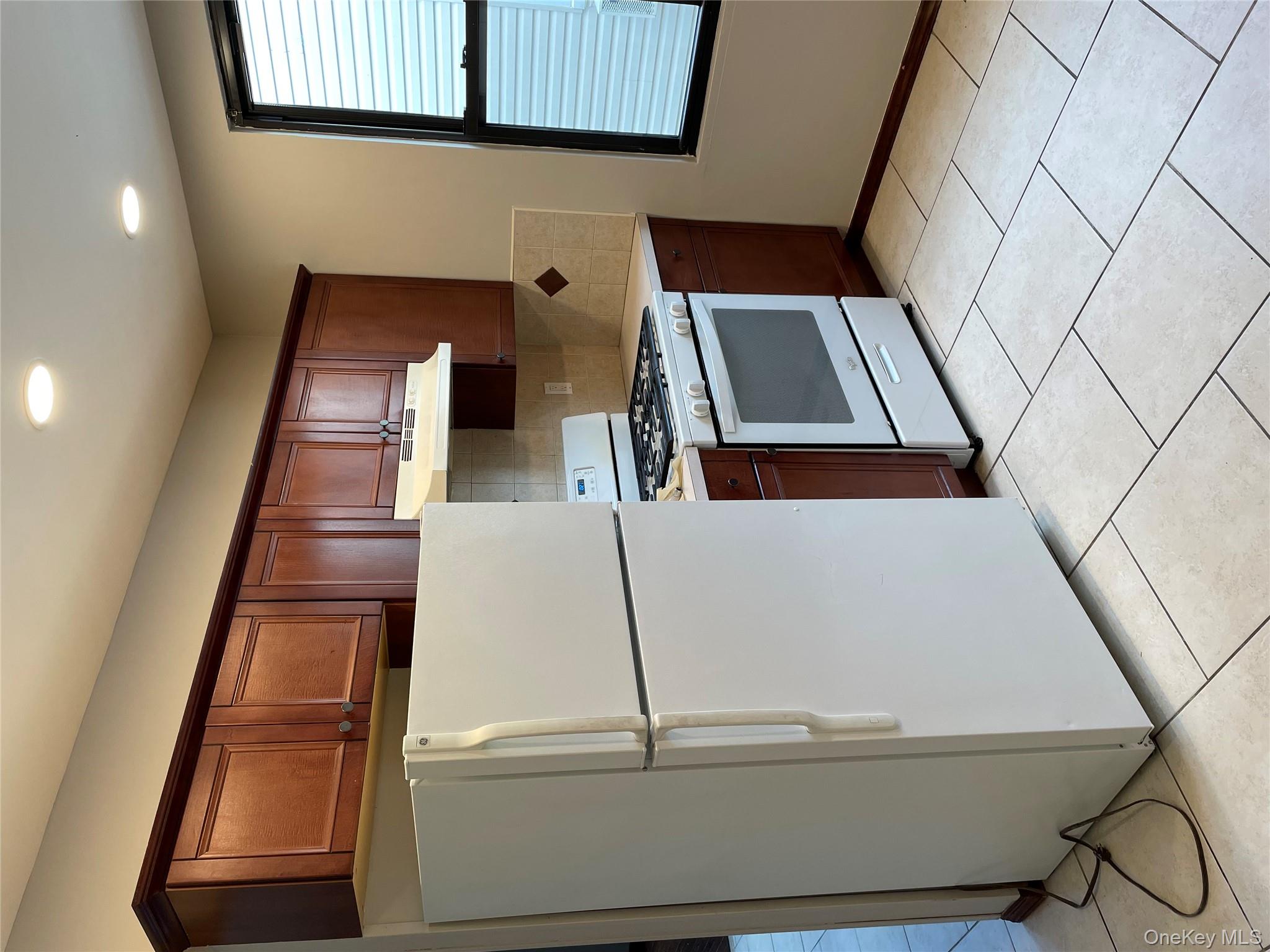 78-45 79th Place Queens, NY 11385 - Photo 21 of 36 a kitchen with stainless steel appliances a refrigerator stove and microwave