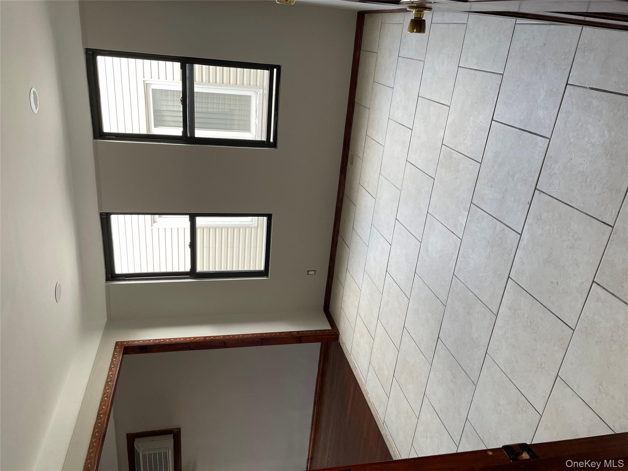 78-45 79th Place Queens, NY 11385 - Photo 22 of 36 a view of an empty room with a window