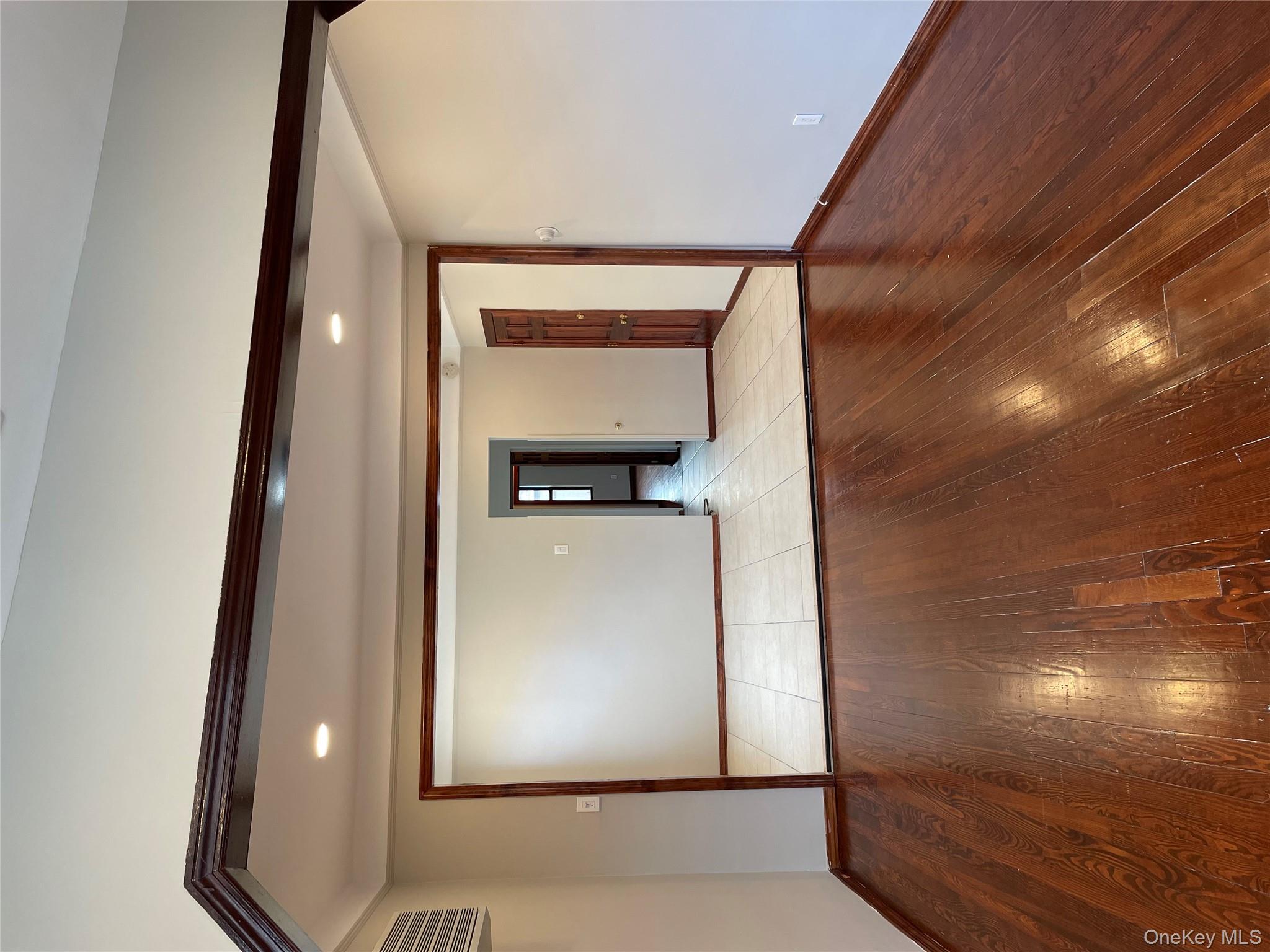 78-45 79th Place Queens, NY 11385 - Photo 25 of 36 a view of an empty room and wooden floor
