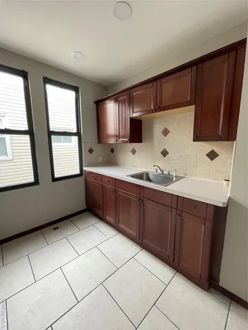 a kitchen with a cabinets a refrigerator and a stove top oven