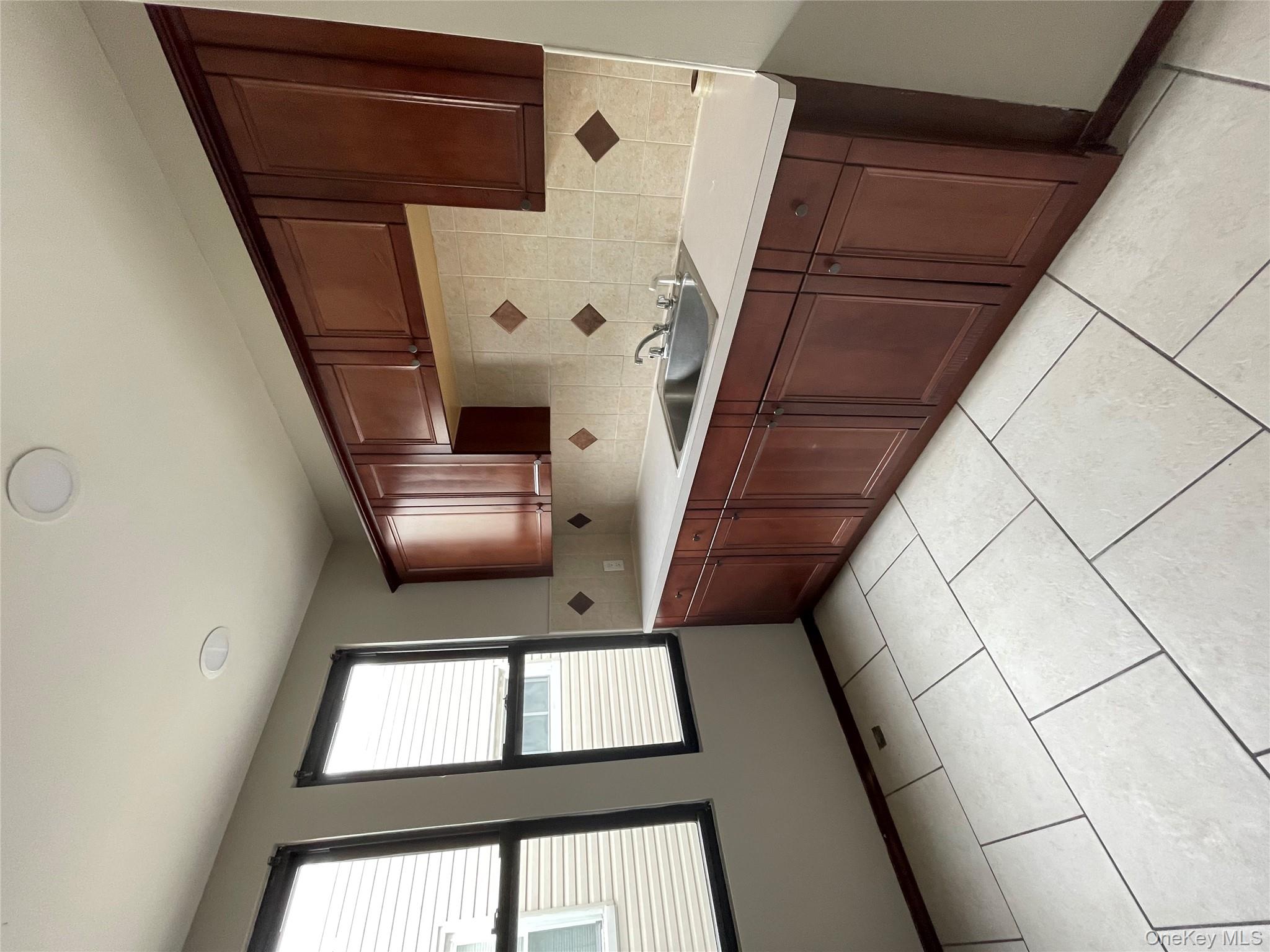 78-45 79th Place Queens, NY 11385 - Photo 32 of 36 a kitchen with stainless steel appliances a sink a stove and a refrigerator