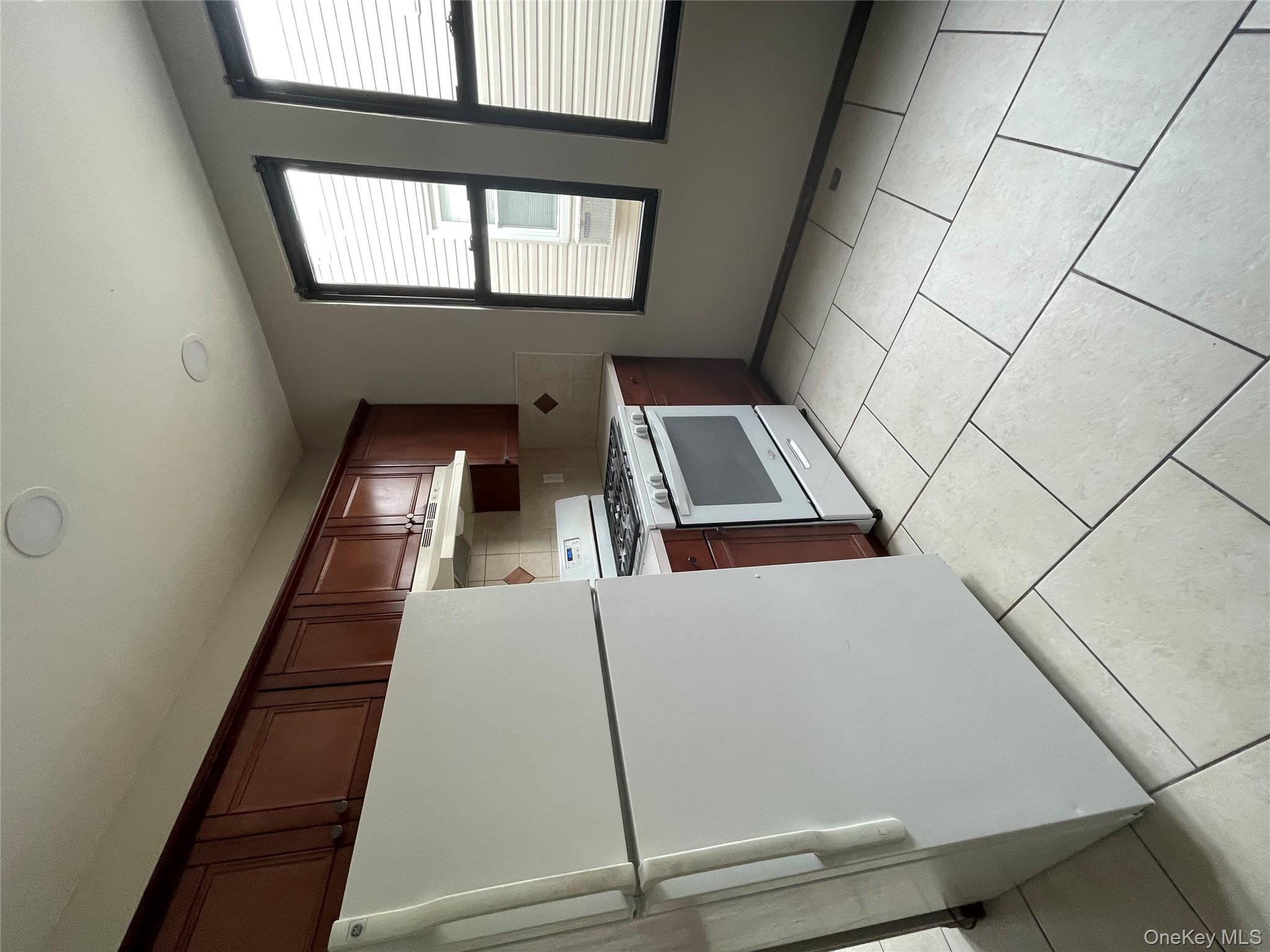 78-45 79th Place Queens, NY 11385 - Photo 33 of 36 a kitchen with a cabinets a refrigerator and a stove top oven