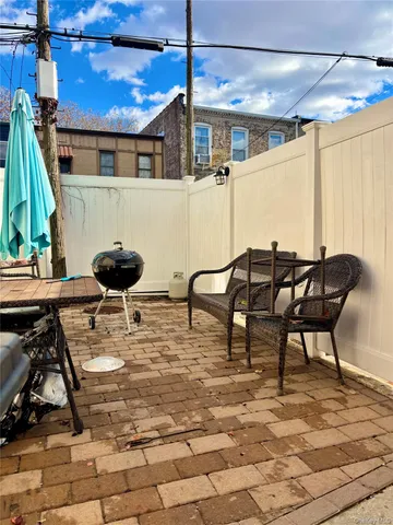 a view of a patio with table and chairs