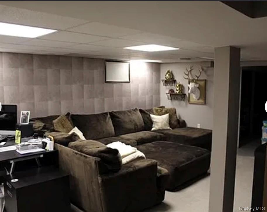 78-45 79th Place Queens, NY 11385 - Photo 9 of 36 a living room with furniture and a flat screen tv