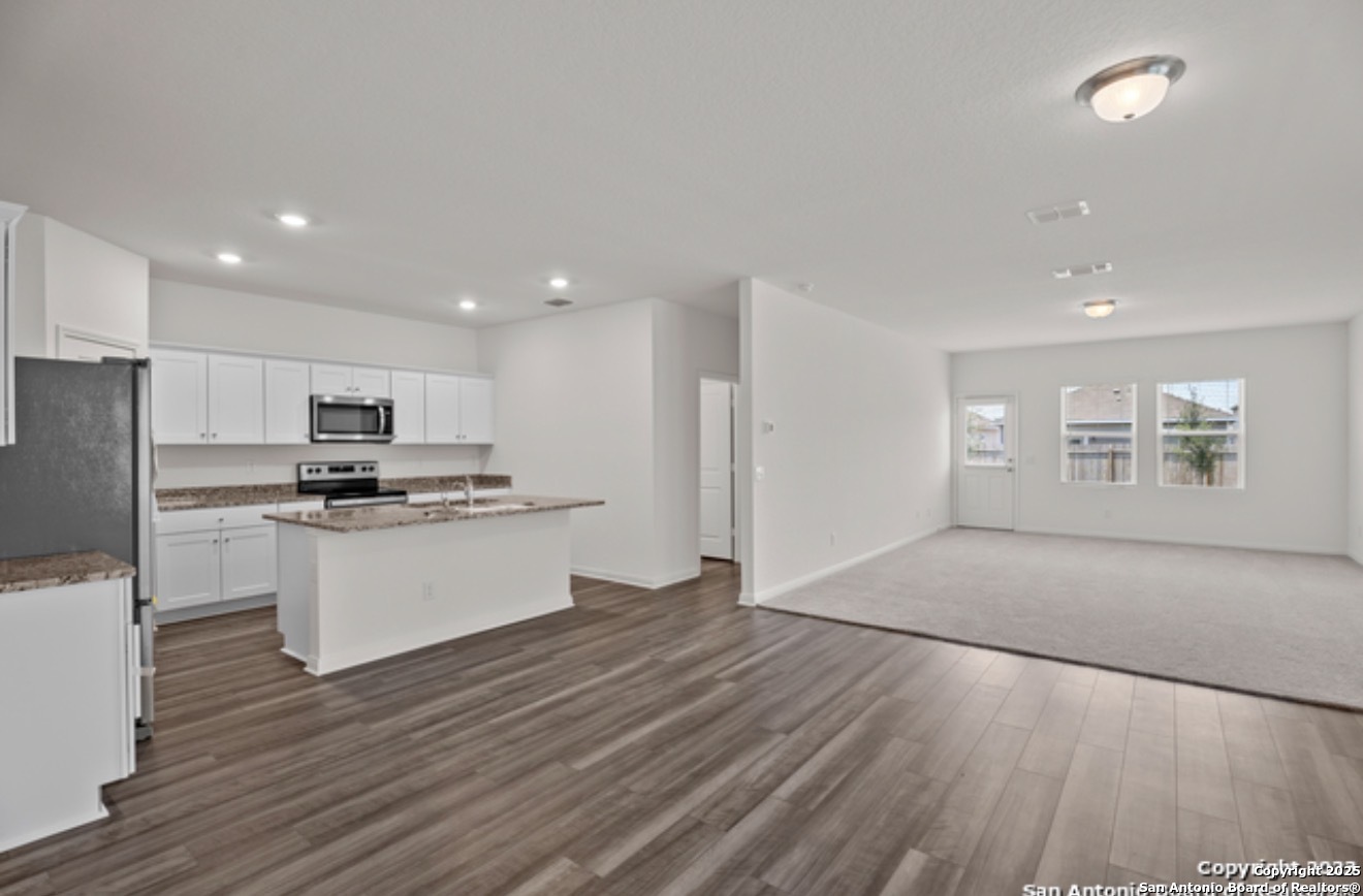 14677 Maple Terrace San Antonio, TX 78253 - Photo 13 of 13 a kitchen with a refrigerator and a stove top oven