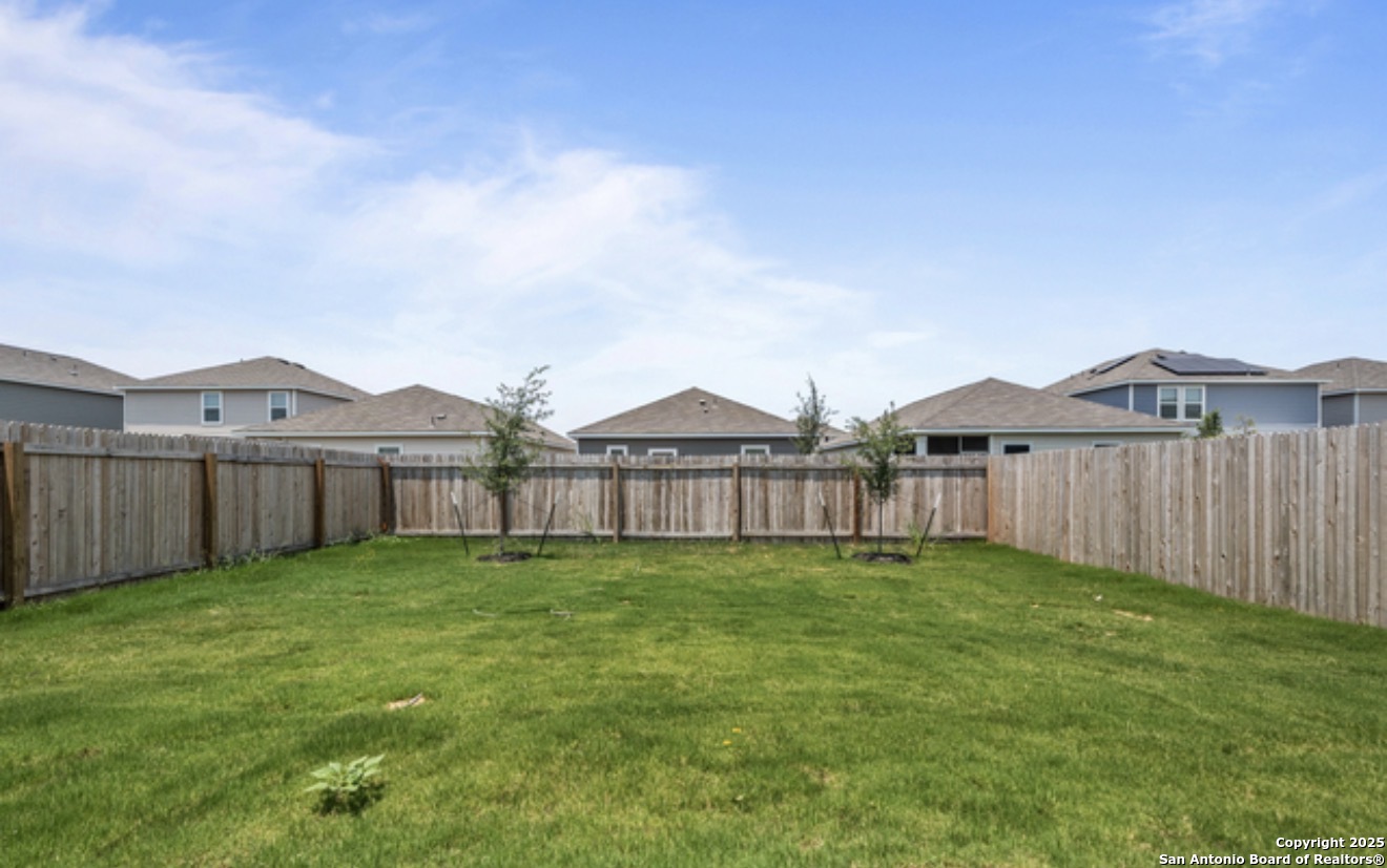 14677 Maple Terrace San Antonio, TX 78253 - Photo 2 of 13 a view of a big house with a yard and wooden fence