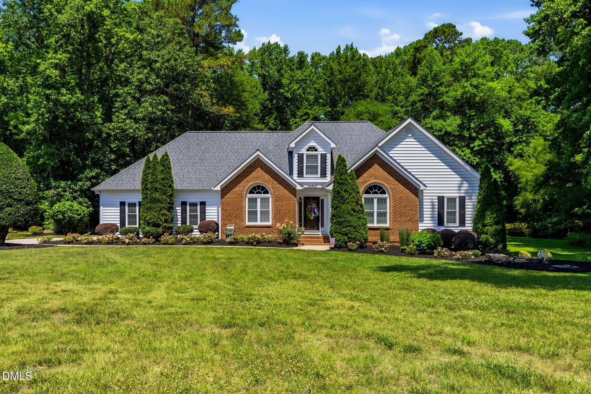 1112 Tyler Farms Drive Raleigh, NC 27603 - Photo 1 of 78 a front view of a house with a yard and trees