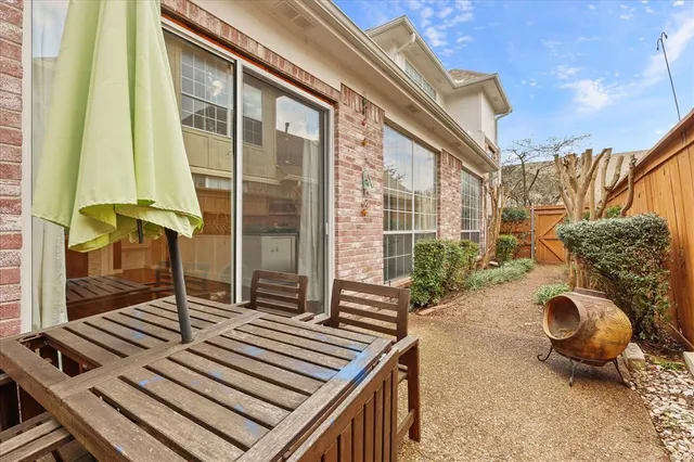 a backyard of a house with table and chairs