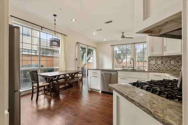 a kitchen with sink stove and wooden floor