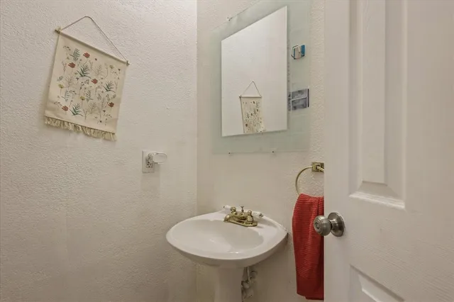a bathroom with a sink and mirror