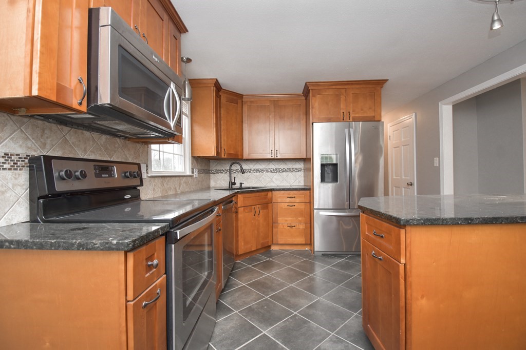 5 Northridge Road Westfield, MA 01085 - Photo 11 of 42 a kitchen with stainless steel appliances granite countertop a sink stove and refrigerator