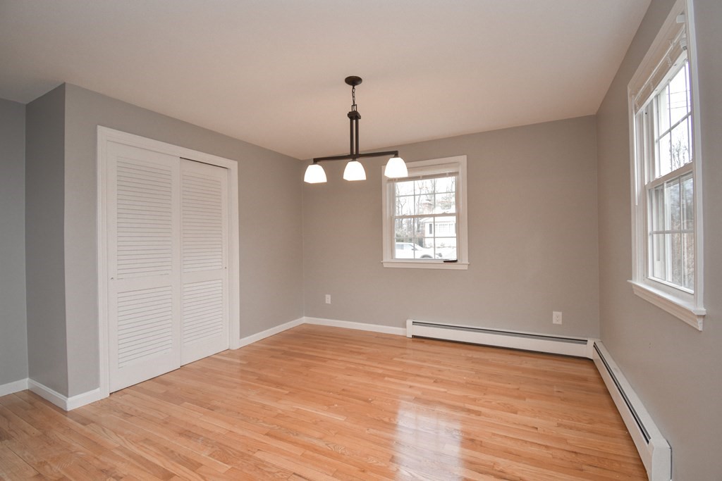 5 Northridge Road Westfield, MA 01085 - Photo 16 of 42 an empty room with wooden floor chandelier and windows