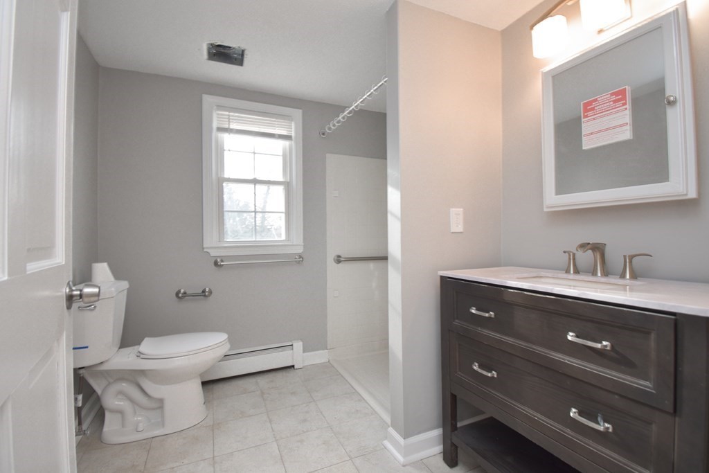 5 Northridge Road Westfield, MA 01085 - Photo 22 of 42 a bathroom with a granite countertop toilet a sink and mirror