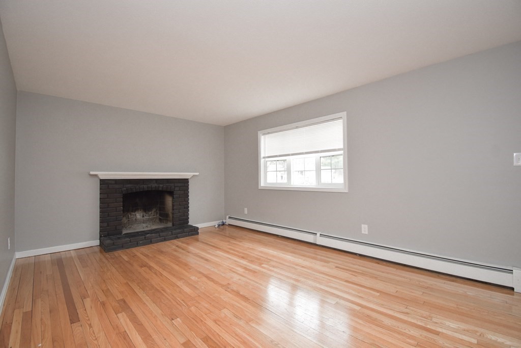 5 Northridge Road Westfield, MA 01085 - Photo 4 of 42 an empty room with wooden floor a fireplace and windows