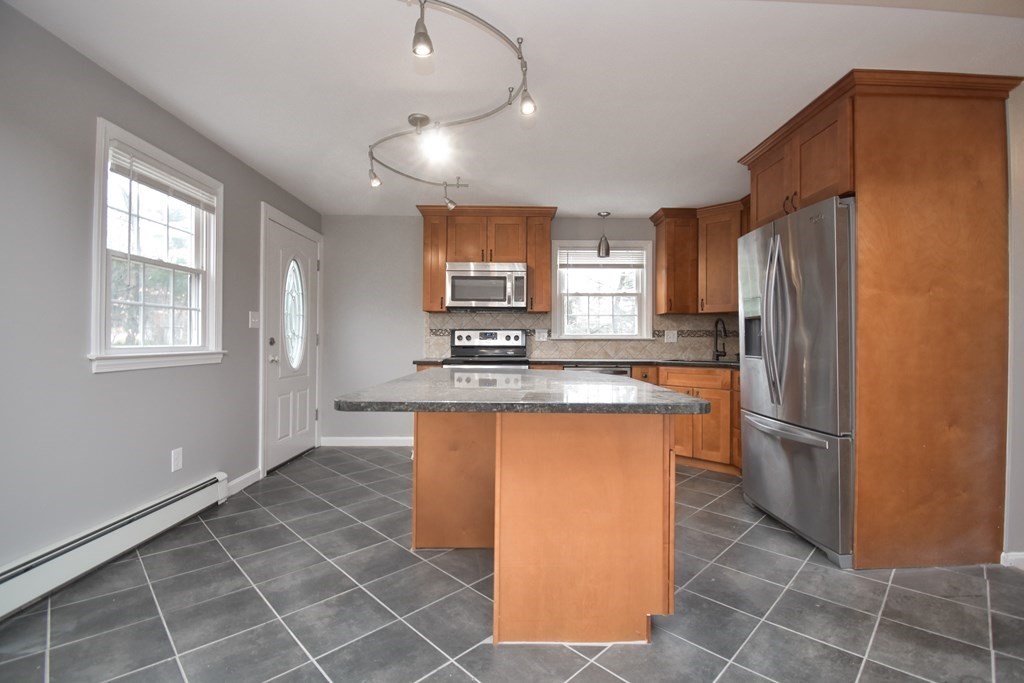 5 Northridge Road Westfield, MA 01085 - Photo 9 of 42 a kitchen with stainless steel appliances granite countertop a refrigerator a sink a stove a microwave and island