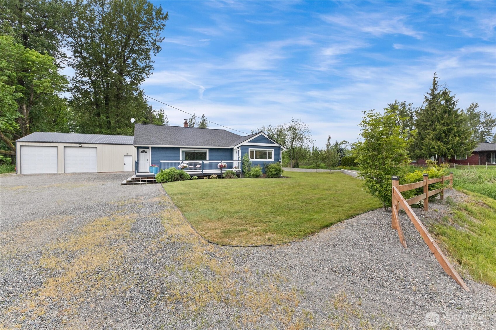 9007 Van Buren Road Everson, WA 98247 - Photo 1 of 36 a view of a white house with a big yard and potted plants
