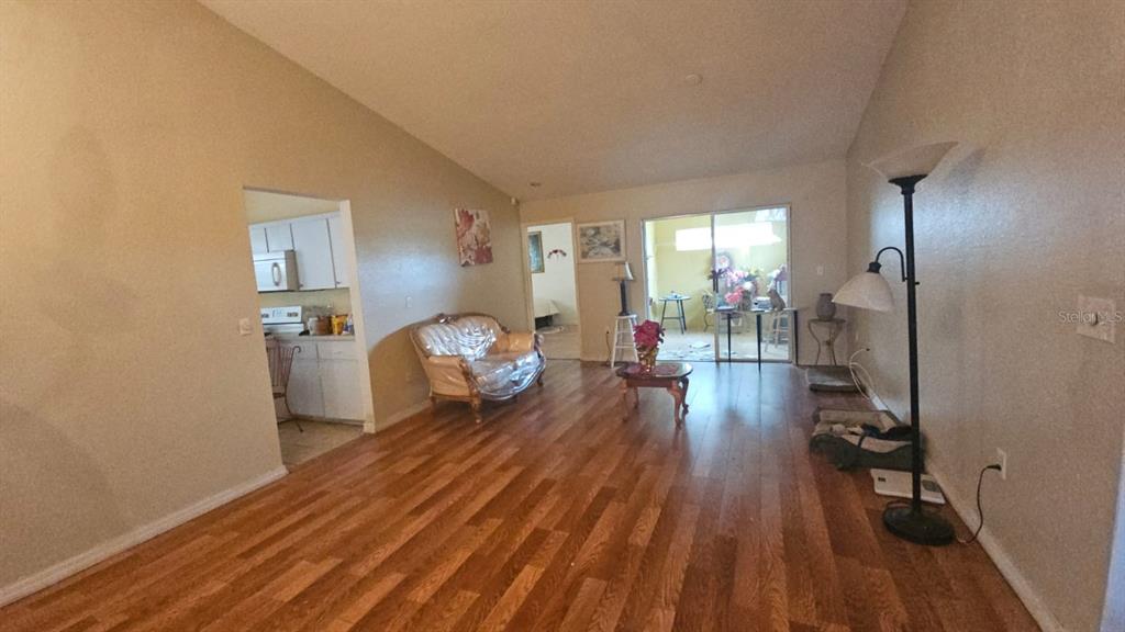 871 Reflections Loop East Winter Haven, FL 33884 - Photo 2 of 23 a living room with furniture and a wooden floor