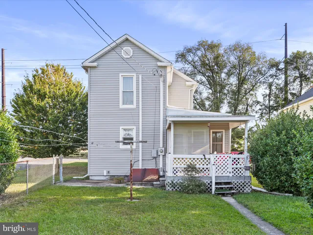 a front view of a house with a garden and plants