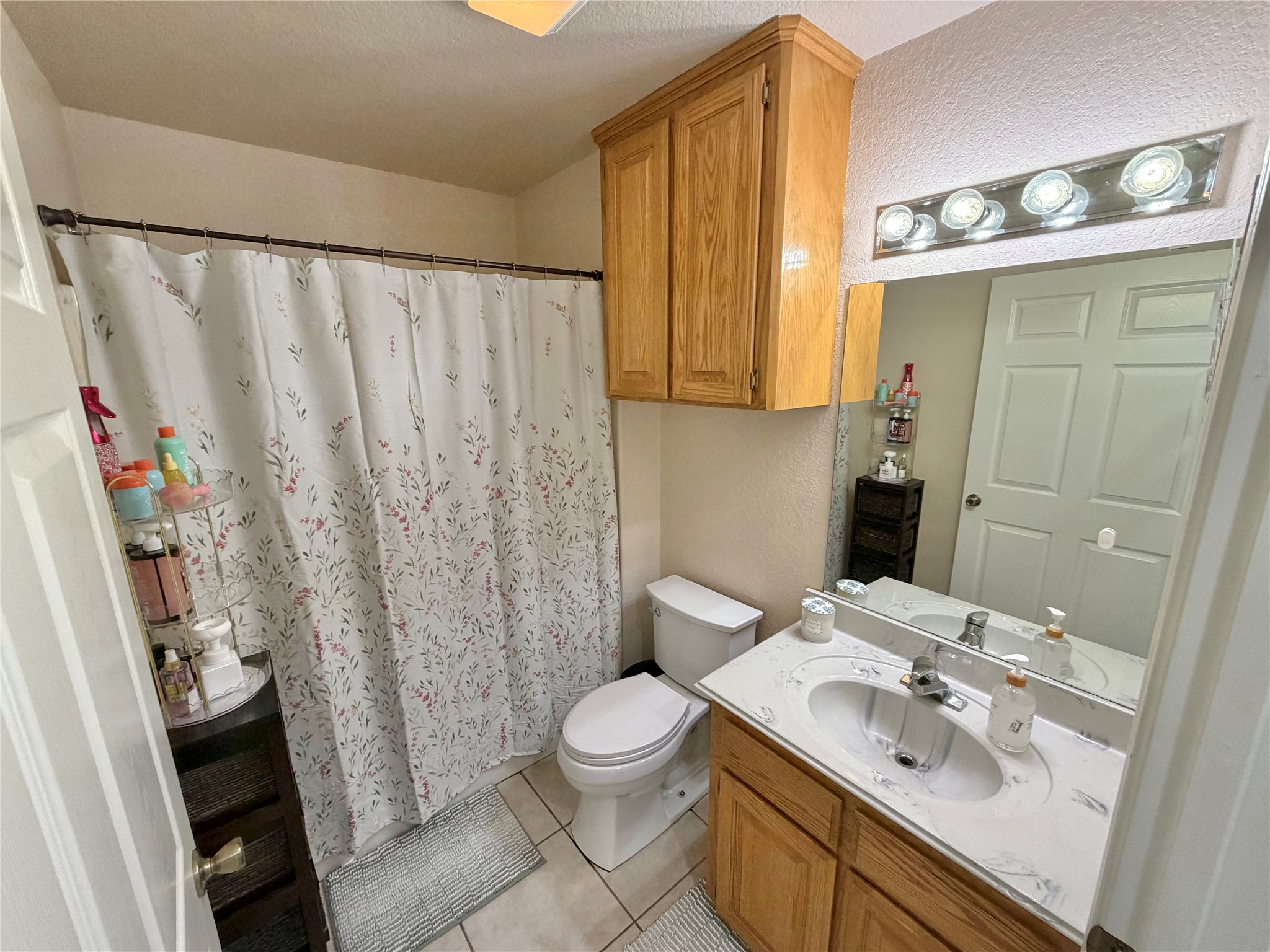 15903 County Road 621 Angleton, TX 77515 - Photo 25 of 33 a bathroom with a sink a toilet and shower curtain