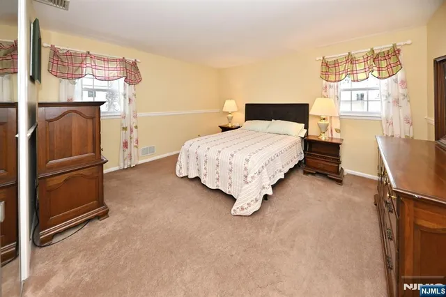 a bedroom with a bed and cabinets