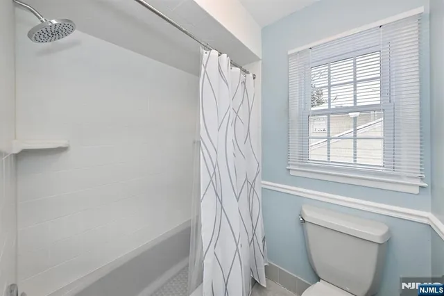 a bathroom with a sink a toilet and a shower