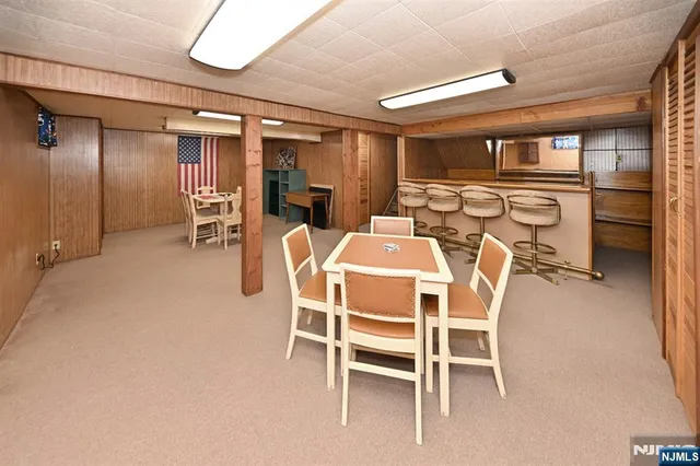 a dining room with furniture and a window