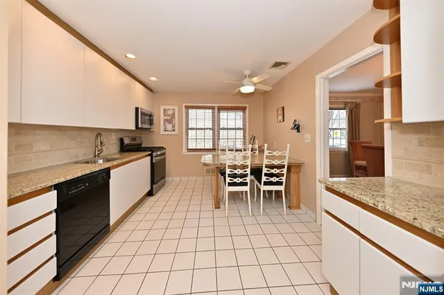a kitchen with granite countertop a sink cabinets and counter space