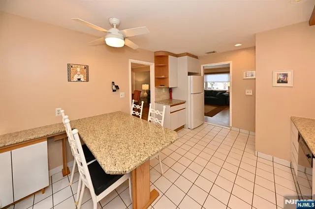a living room with stainless steel appliances kitchen island granite countertop furniture and a kitchen view