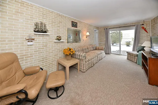 a bedroom with furniture and a large window