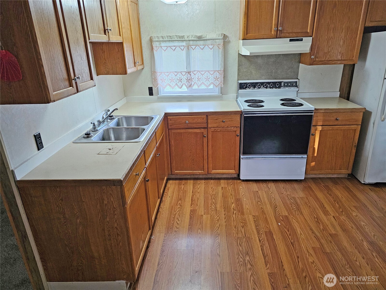 18525 Sargent Road Southwest Rochester, WA 98579 - Photo 26 of 37 a kitchen with a sink stove and cabinets