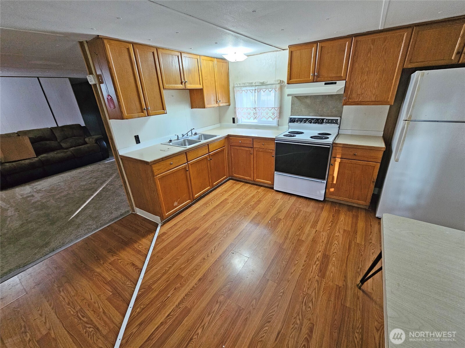 18525 Sargent Road Southwest Rochester, WA 98579 - Photo 27 of 37 a kitchen with stainless steel appliances wooden floors sink and cabinets